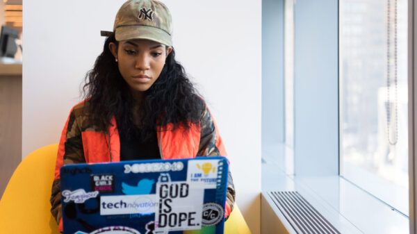 Woman sits typing on her laptop