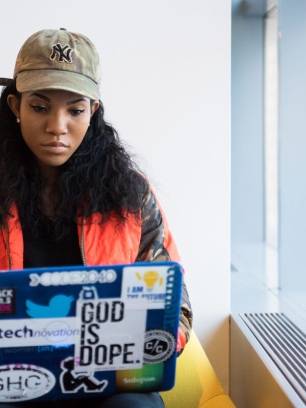 Woman sits typing on her laptop