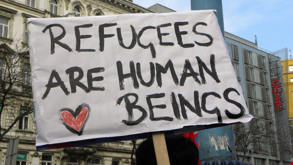 Sign reads "Refugees are human beings."