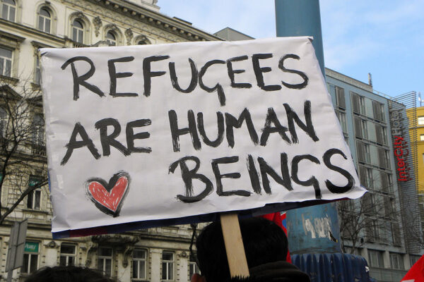 Sign reads "Refugees are human beings."