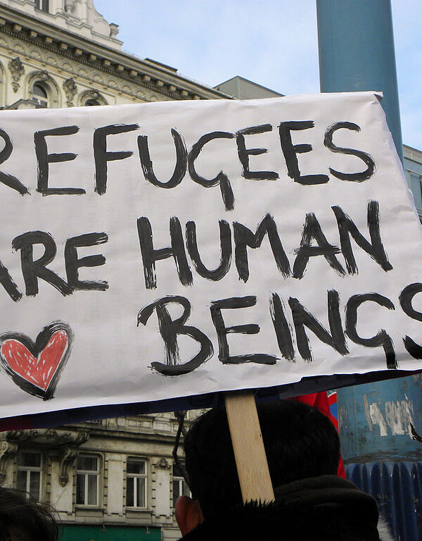 Sign reads "Refugees are human beings."