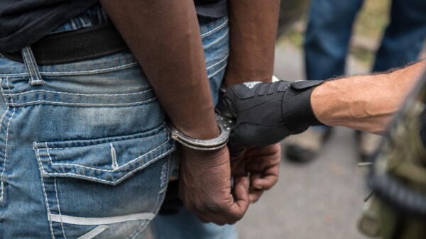Police put a black person in handcuffs