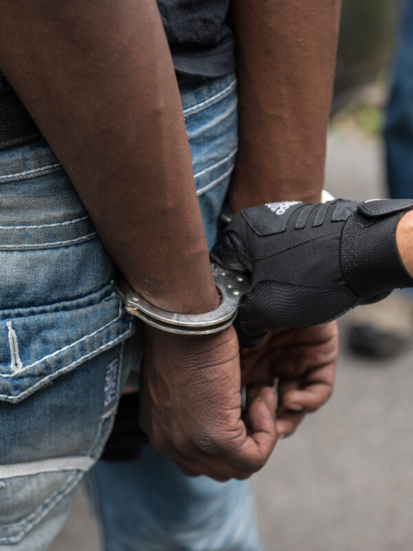 Police put a black person in handcuffs