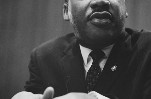 1964 photo of Martin Luther King Jr. leaning on a lectern