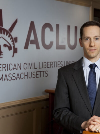 Matthew Segal in front of ACLU Logo