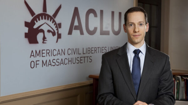 Matthew Segal in front of ACLU Logo