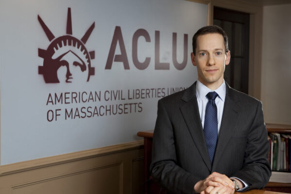 Matthew Segal in front of ACLU Logo