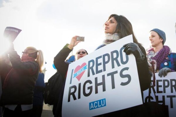 Woman holds "I heart repro rights" sign