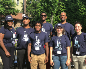Canvassers stand in front of trees wearing ACLU t-shirts