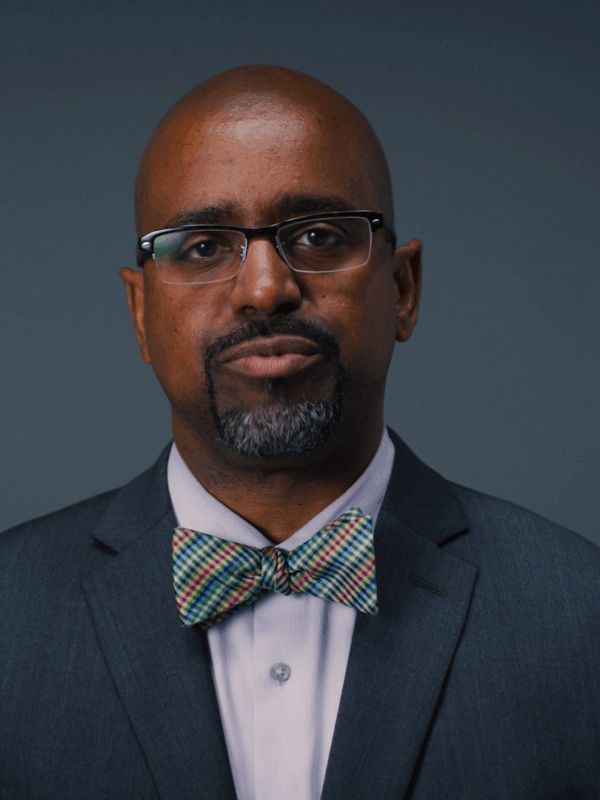 Rahsaan Hall, director of the ACLU of Massachusetts' Racial Justice Program and What a Difference a DA Makes campaign manager in front of a gray background