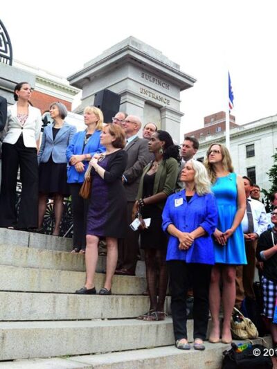Supporters of transgender rights line the steps of the Massachusetts State House during the citizens signing of the transgender anti-discrimination bill