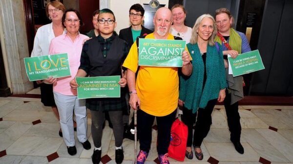 Supporters of transgender rights hold signs in support of transgender equality in the Massachusetts State House