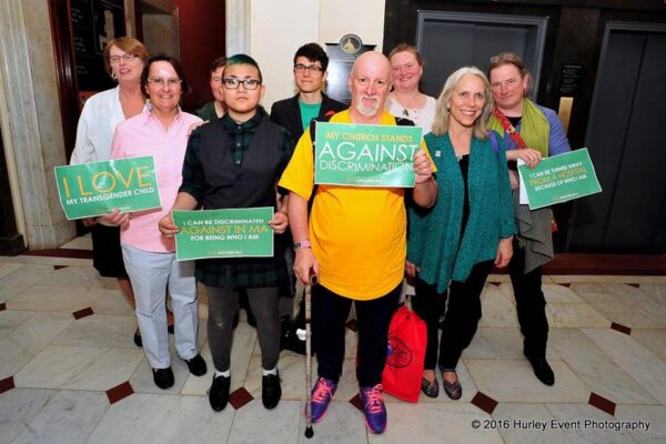 Supporters of transgender rights hold signs in support of transgender equality in the Massachusetts State House