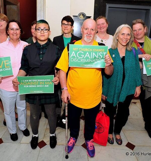 Supporters of transgender rights hold signs in support of transgender equality in the Massachusetts State House