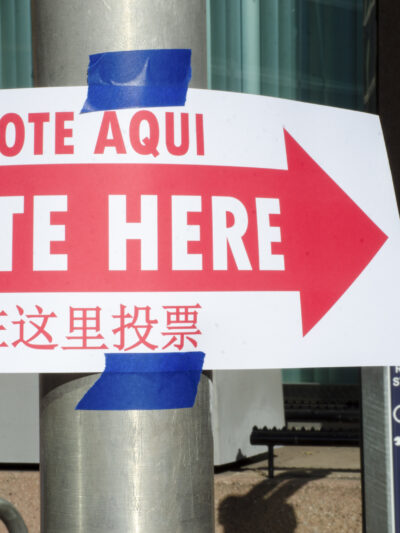 Photo of "Vote Here" sign on pole