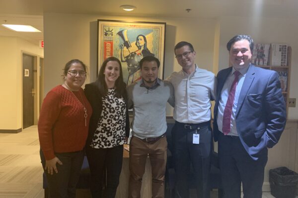 Julio Ramirez stands with members of his legal team in the ACLU of Massachusetts office