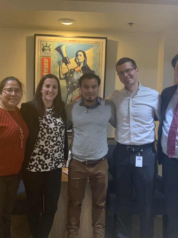 Julio Ramirez stands with members of his legal team in the ACLU of Massachusetts office