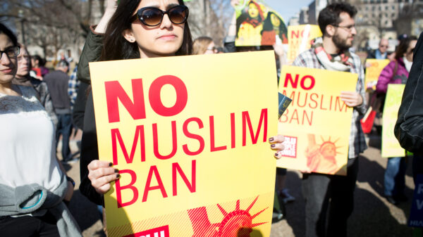 Woman holding No Muslim Ban sign