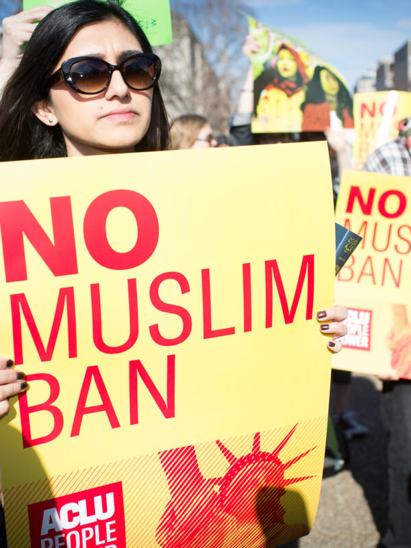 Woman holding No Muslim Ban sign