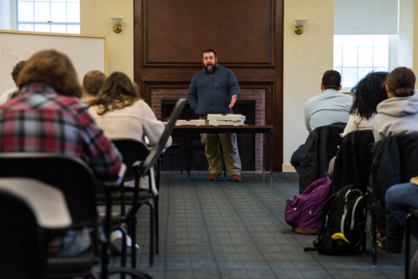 Volunteers sit in rows as ACLU staffer leads training in front