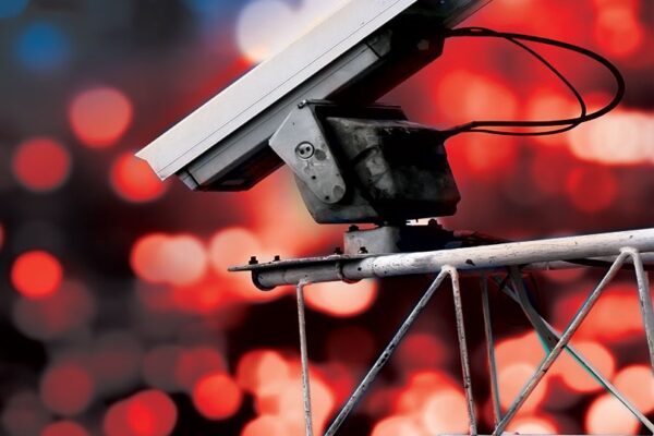 Surveillance camera high above blurred city lights