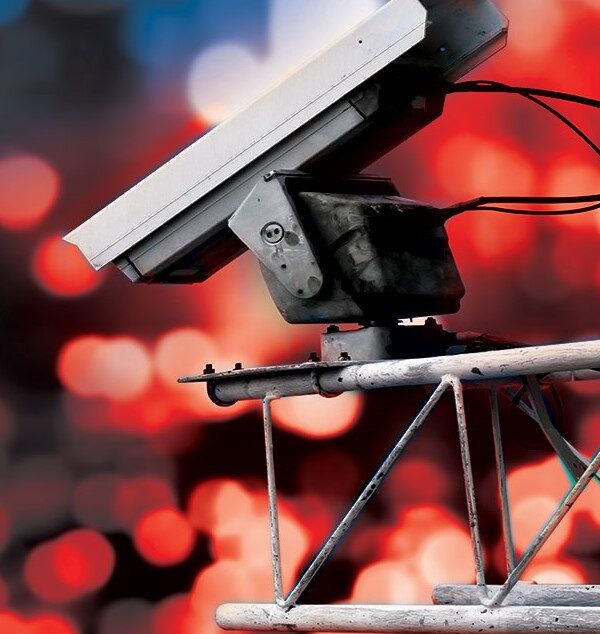 Surveillance camera high above blurred city lights