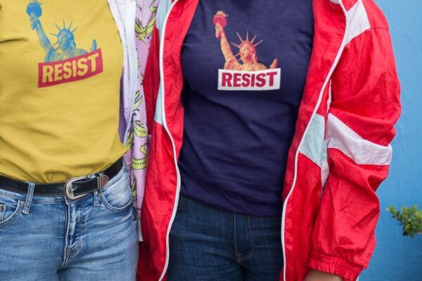 Two people wearing ACLU Resist t-shirts