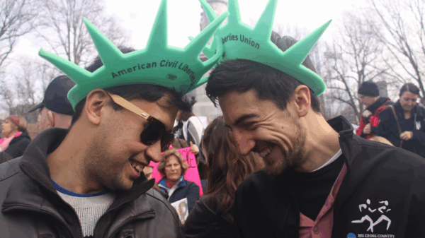 Two ACLU of Massachusetts volunteers wearing Statue of Liberty hats