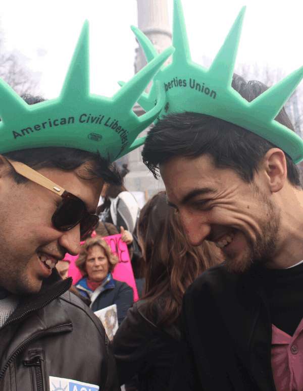 Two ACLU of Massachusetts volunteers wearing Statue of Liberty hats