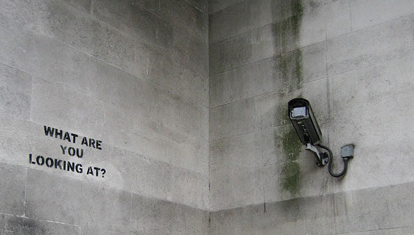 Surveillance camera and words "what are you looking at?"