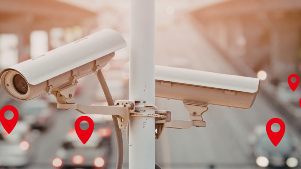 Automatic License plate readers above a highway in daylight. Location pins demonstrate tracking of vehicles in the background.
