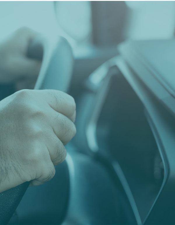 Individual driving a vehicle with light blue overlay