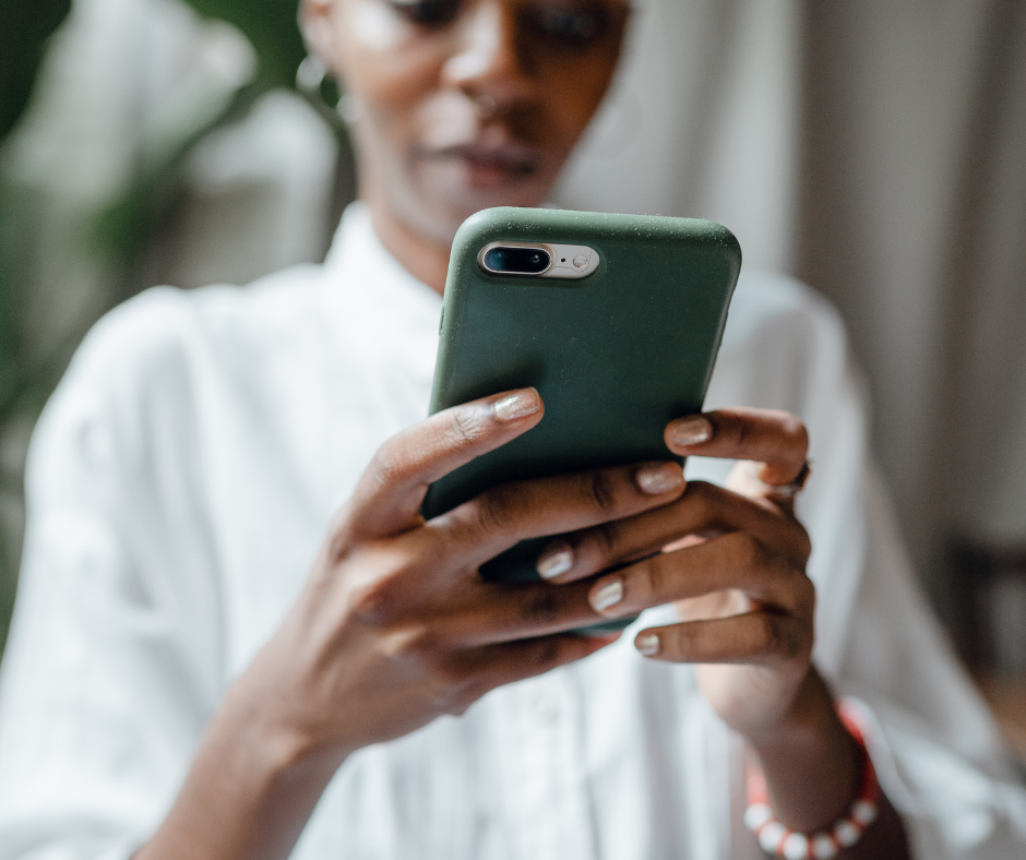 Person holding a teal colored phone texting.