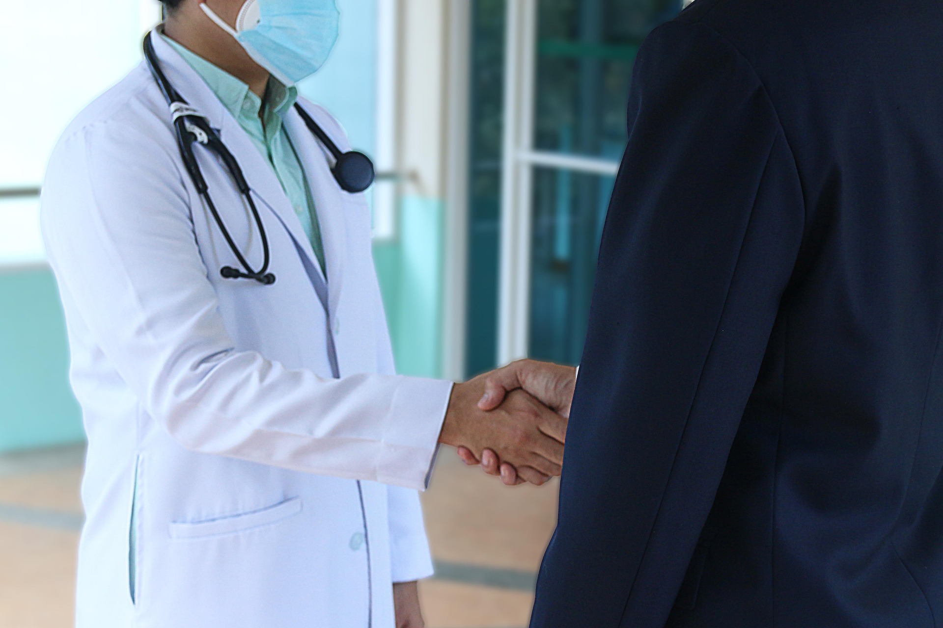 Doctor and patient shaking hands by herbert11timtim
