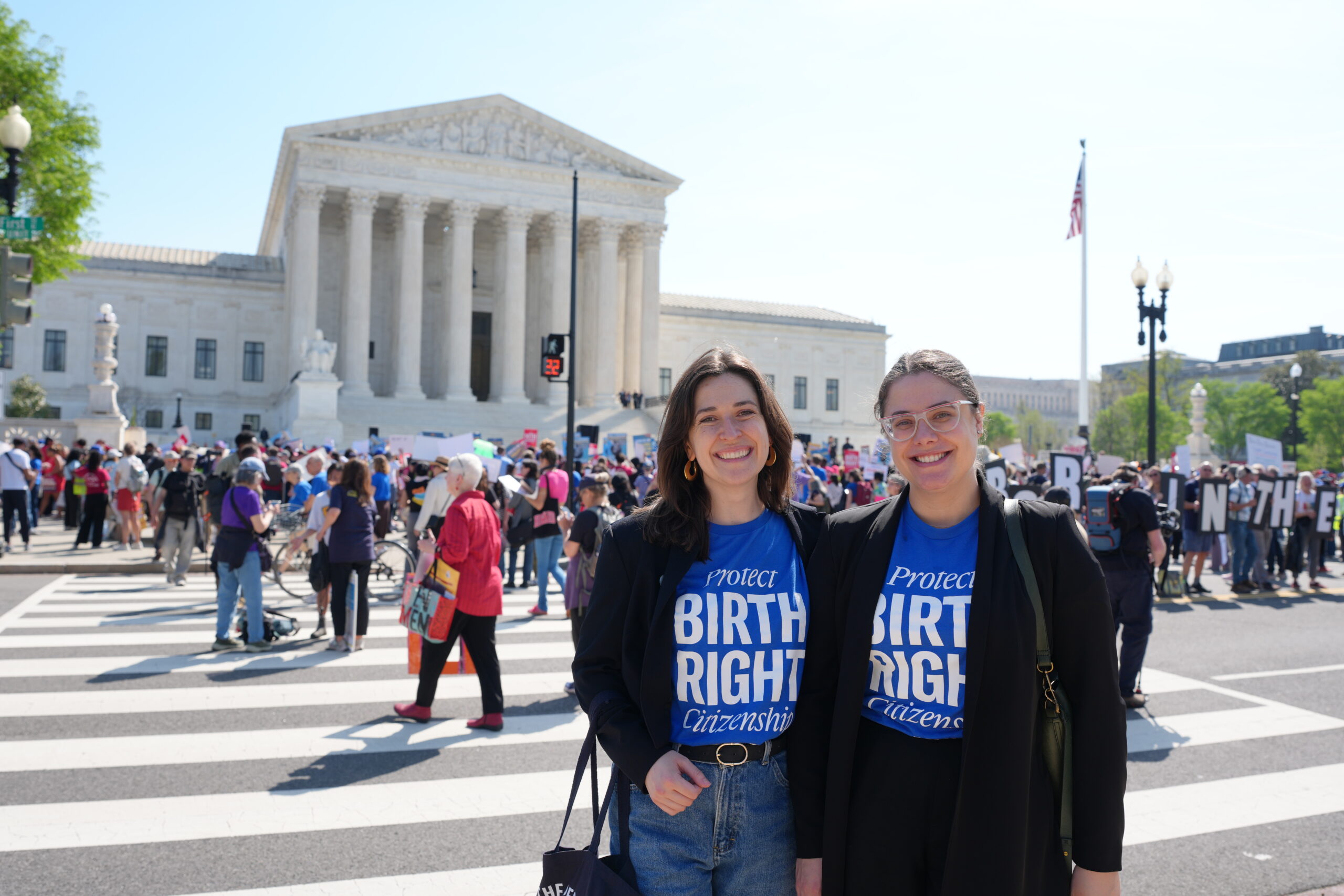 ACLU of Massachusetts Legal fellows outside the Supreme Court oral arguments in Barbara v. Trump on April 1, 2026. They are seen in blue t-shirts that read "Protect birthright Citizenship"