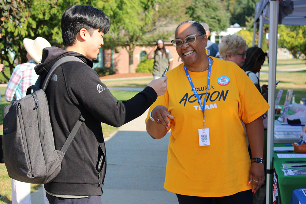 ACLU member giving out know your rights wallet card