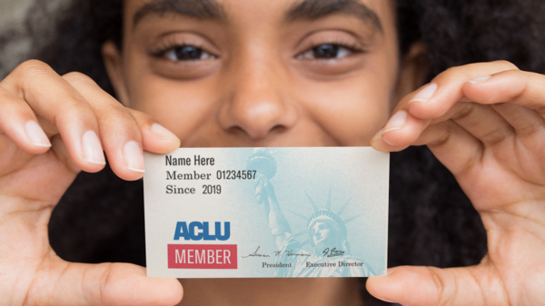 ACLU membership card held in front of an individual's face.