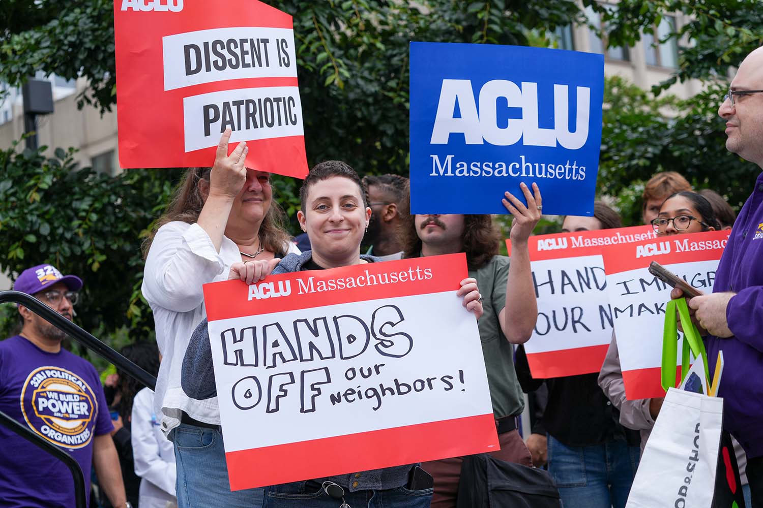 SEIU Immigrants Rights Rally on June 9 2025 with people holding ACLU Massachusetts and Hands off Our Neighbors signs
