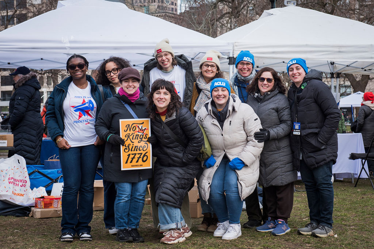 A group of people in ACLU gear rallying together at the third Boston No Kings March on March 28 2026