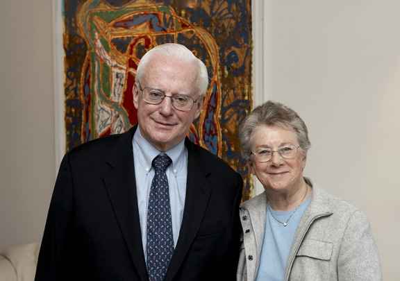 Man and woman standing next to each other smiling