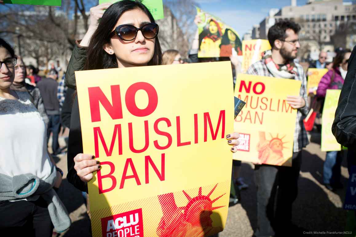 Woman holding No Muslim Ban sign