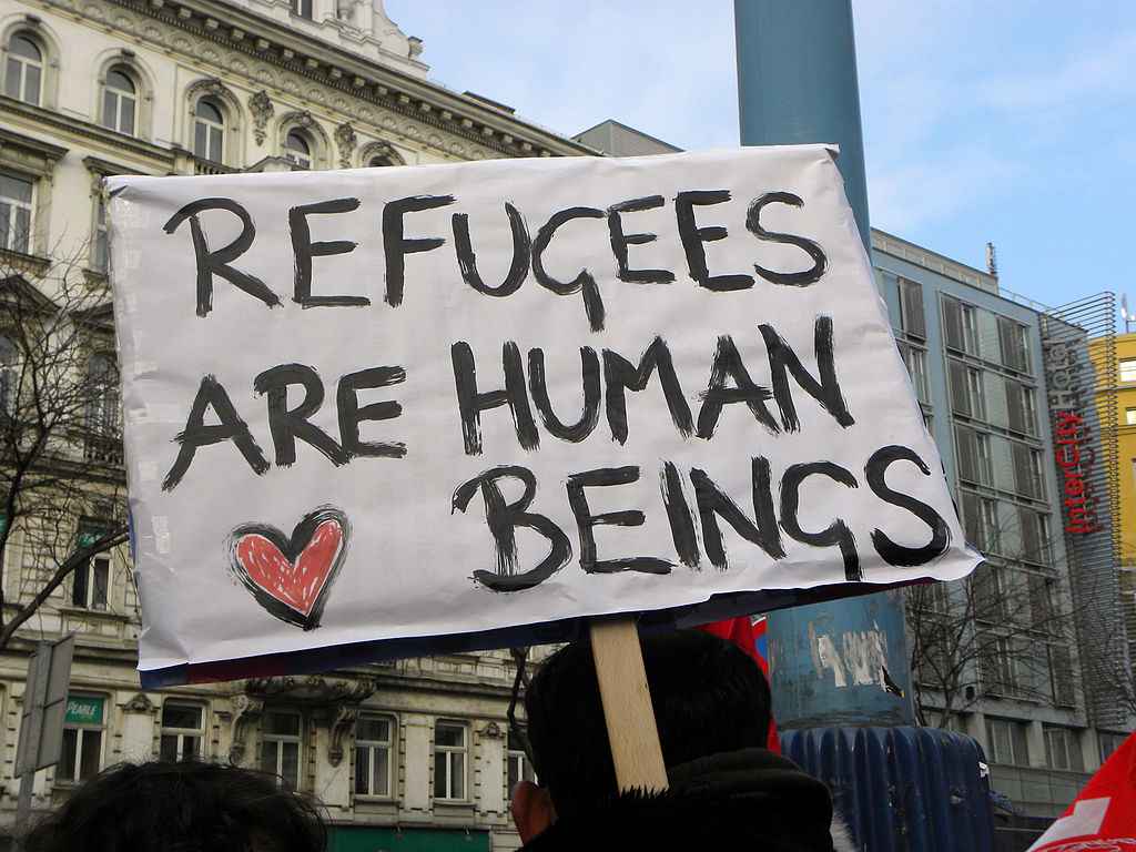 Sign reads &quot;Refugees are human beings.&quot;