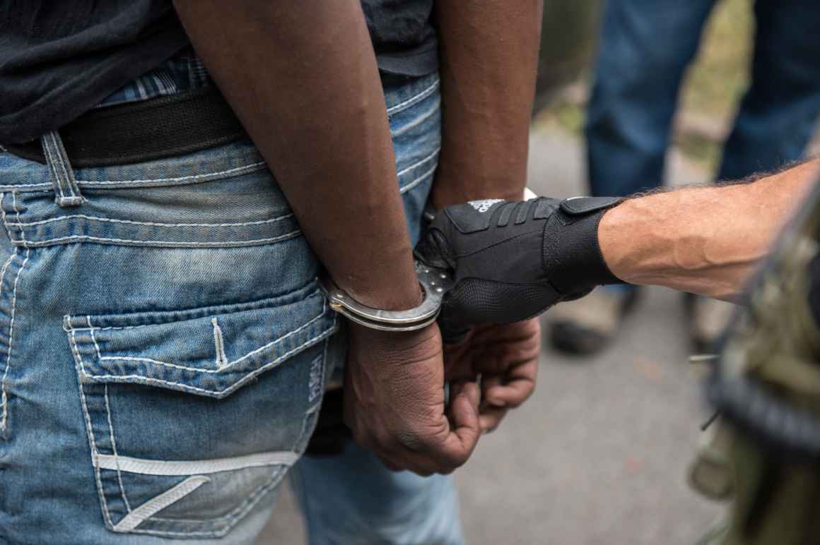 Police put a black person in handcuffs