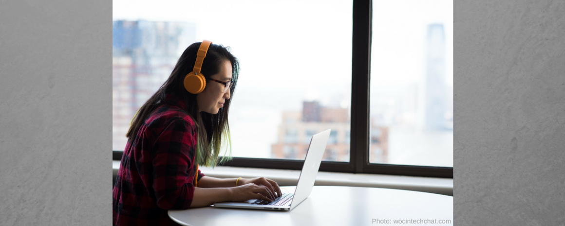 Woman types on laptop stock