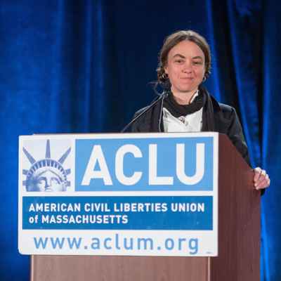 Wenzday Jane at podium with ACLU sign