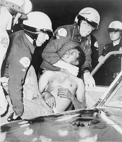 Police arrest a man during the Watts Riots. Image marked as August 12. World-Telegram photo by Ed Palumbo.