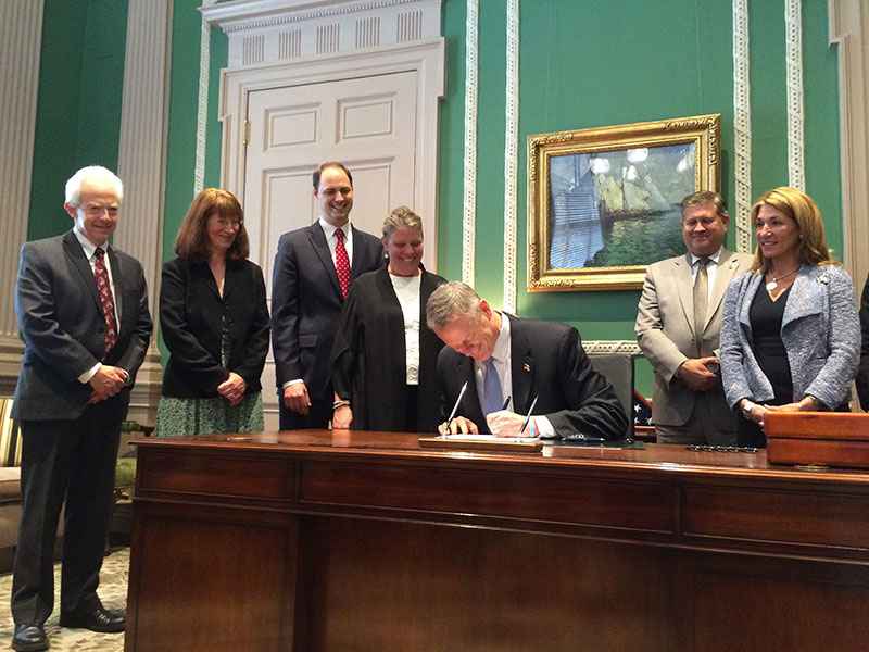 Governor Baker signing the public records bill into law