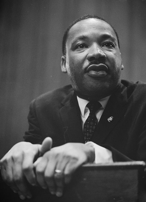 1964 photo of Martin Luther King Jr. leaning on a lectern